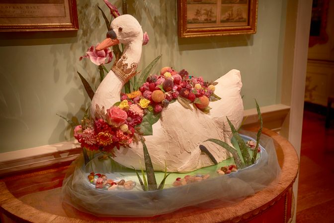 Recreation of swan cake, covered with berries. 