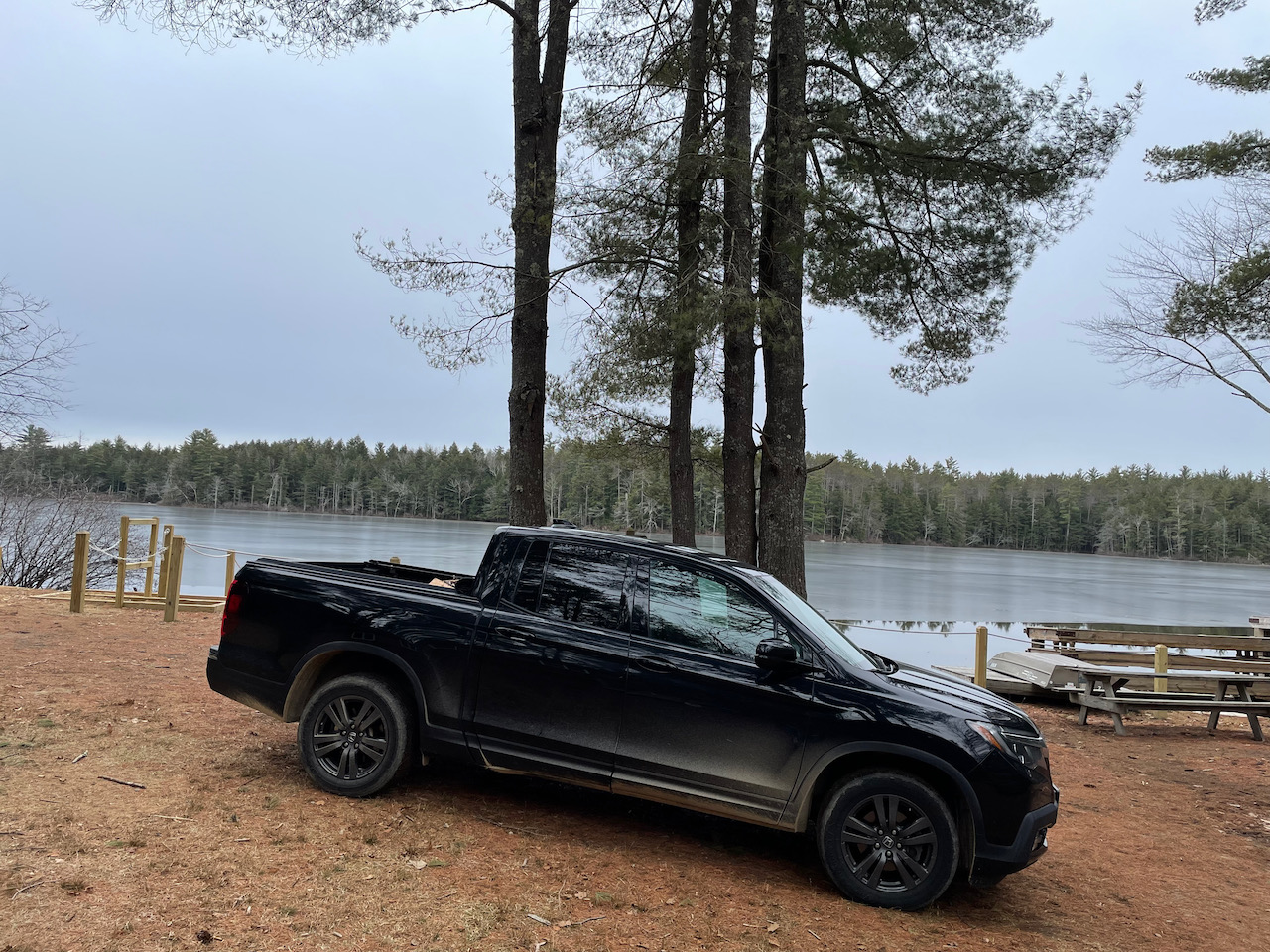 2017 Honda Ridgeline Sport, in black, parked beside lake.