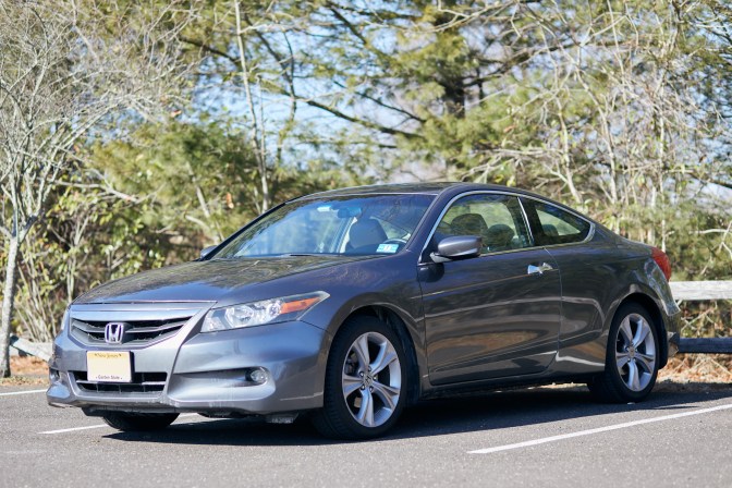 2012 Honda Accord coupe, parked in front of wooden fence.
