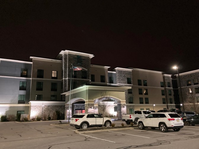 2014 Jeep Grand Cherokee parked in front of hotel.