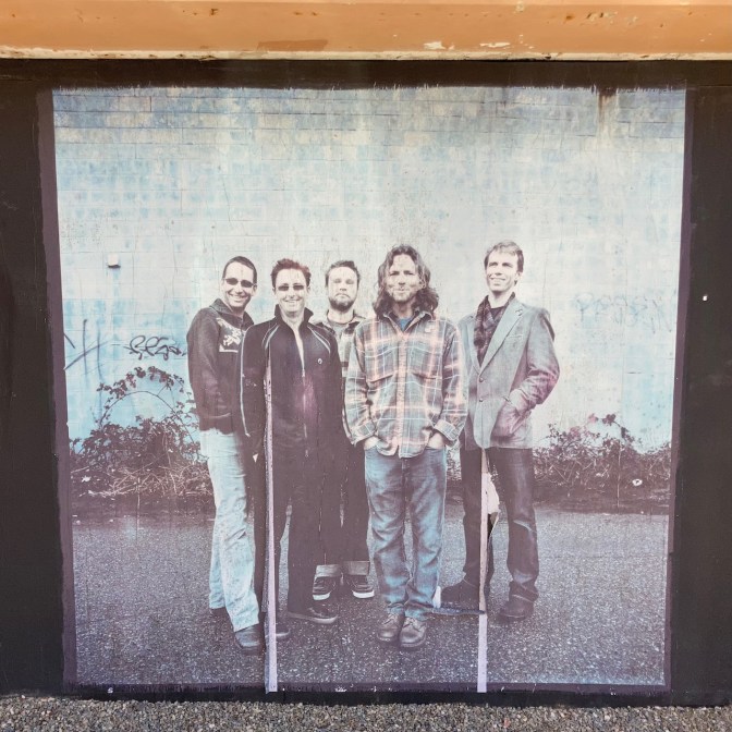 Lifesize photo of Pearl Jam on wall.
