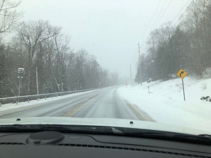 Snow-covered road in mountains.