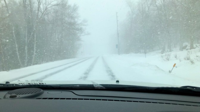 Snow-covered road in mountains.