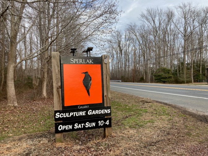 Roadside sign that says SPERLAK SCULPTURE GARDENS OPEN SAT SUN 10-4