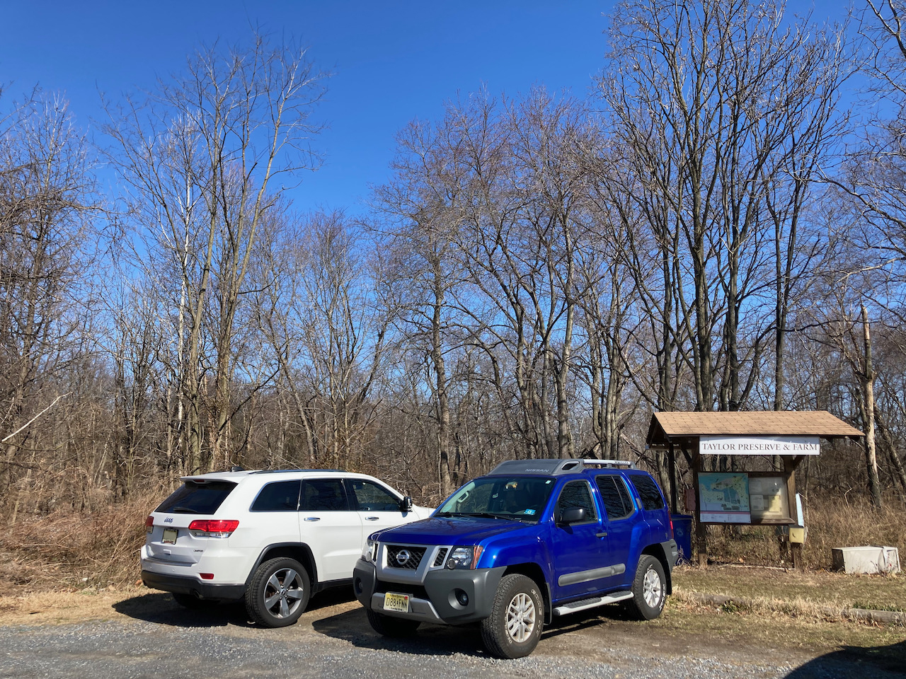 2014 Jeep Grand Cherokee and blue Nissan SUV parked in Taylor Preserve and Farm parking lot.