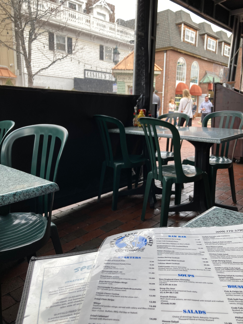 View of Cape May Fish Market Menu on table in outdoor seating area.