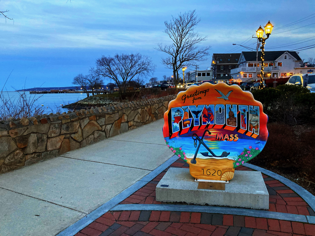 Seashell statue with GREETINGS FROM PLYMOUTH MASS painted on it.