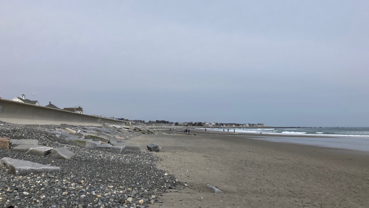 Rocky beach beside ocean.