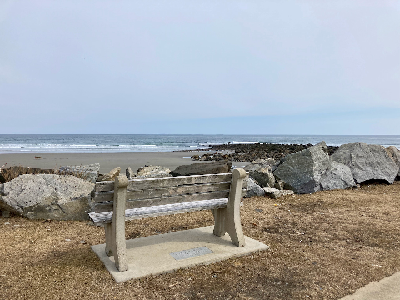 Bench by rocky beach in Rye, New Hampshire.