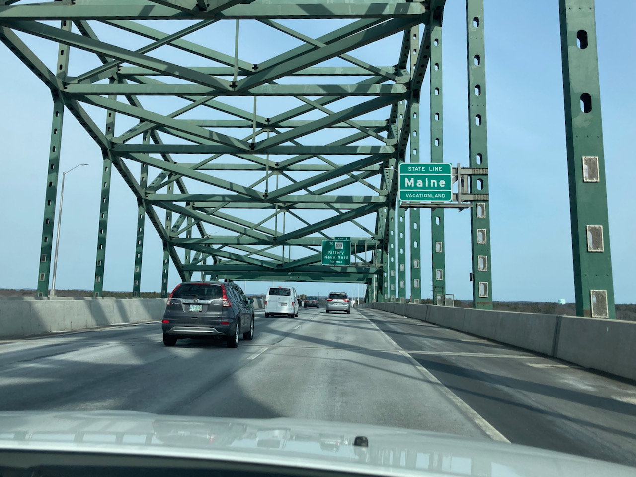 Piscataqua River Bridge with sign that says STATE LINE MAINE VACATIONLAND.