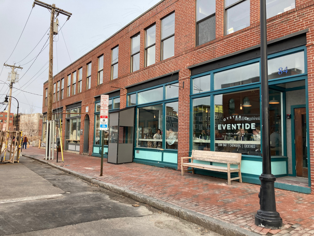 Exterior of two-story brick building with first floor holding a restaurant.