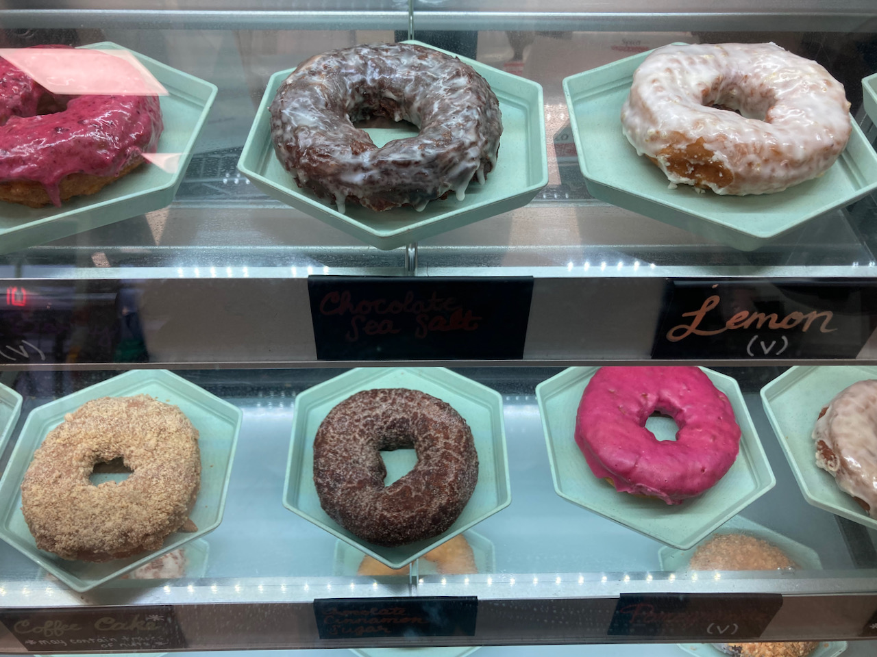 Donuts in glass case.