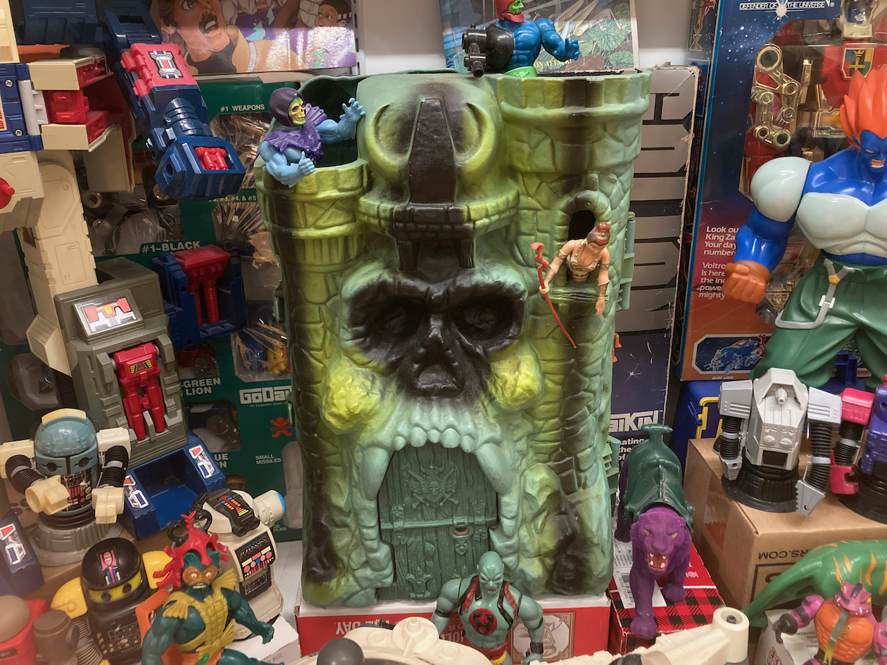 Castle Grayskull and other He-Man toys.