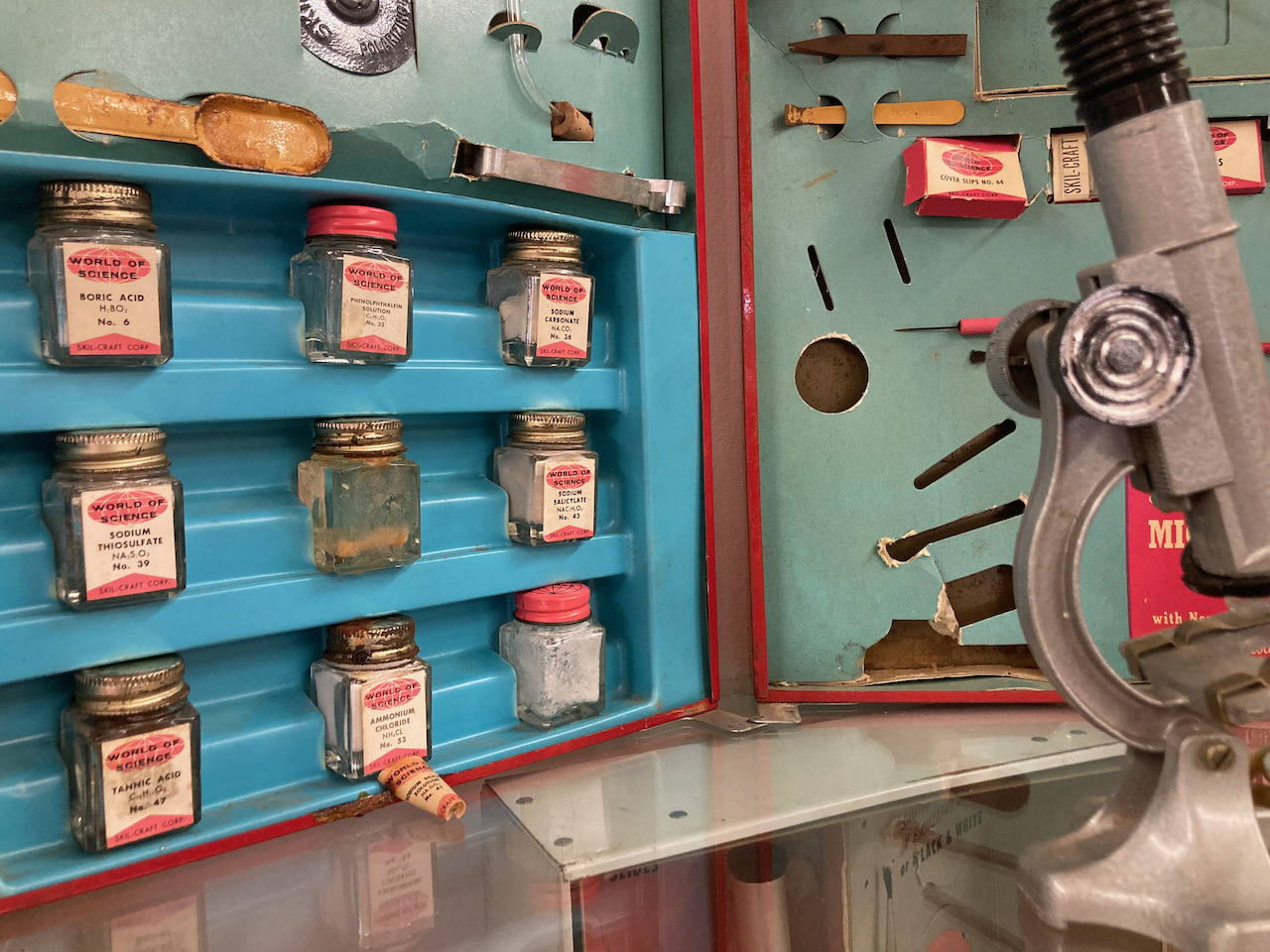 1950s science kit with chemicals in jars.