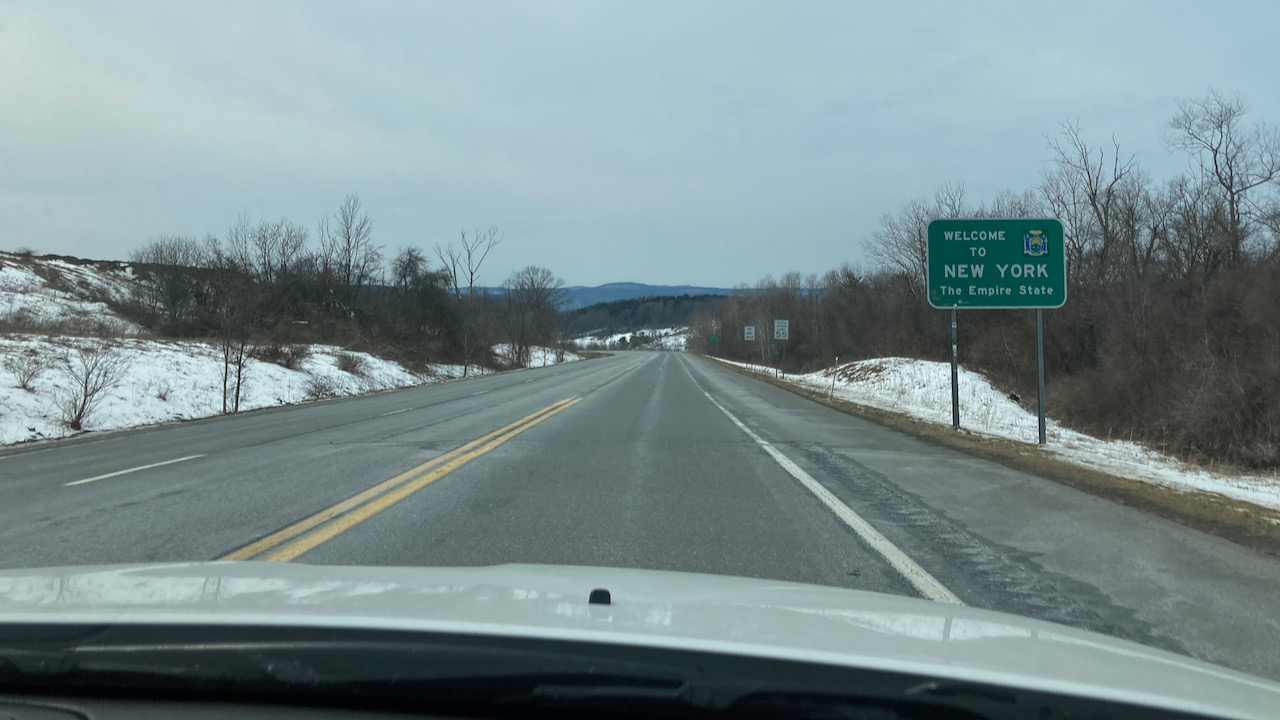 Sign that says WELCOME TO NEW YORK along Route 279.
