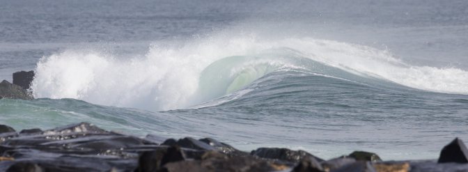 Wave crashing against rocks.