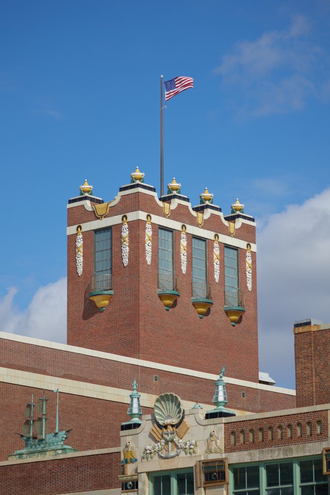 Convention Hall roof, with a large tower that has a flagpole with the American flag.