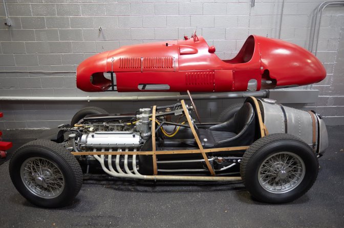 Ferrari/Kurtis Kraft Barahl Special, with red shell removed and bare chassis exposed.