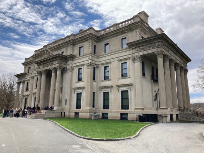 Exterior of Vanderbilt Mansion, with crowd of tourists in front of entrance.