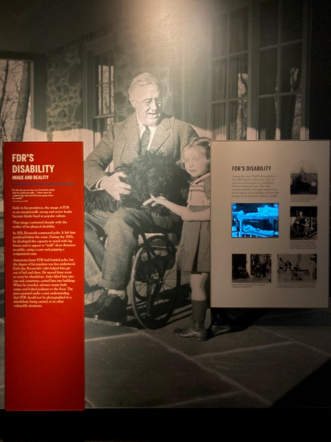 Image of FDR in wheelchair with granddaughter, along with display about FDR's disability.