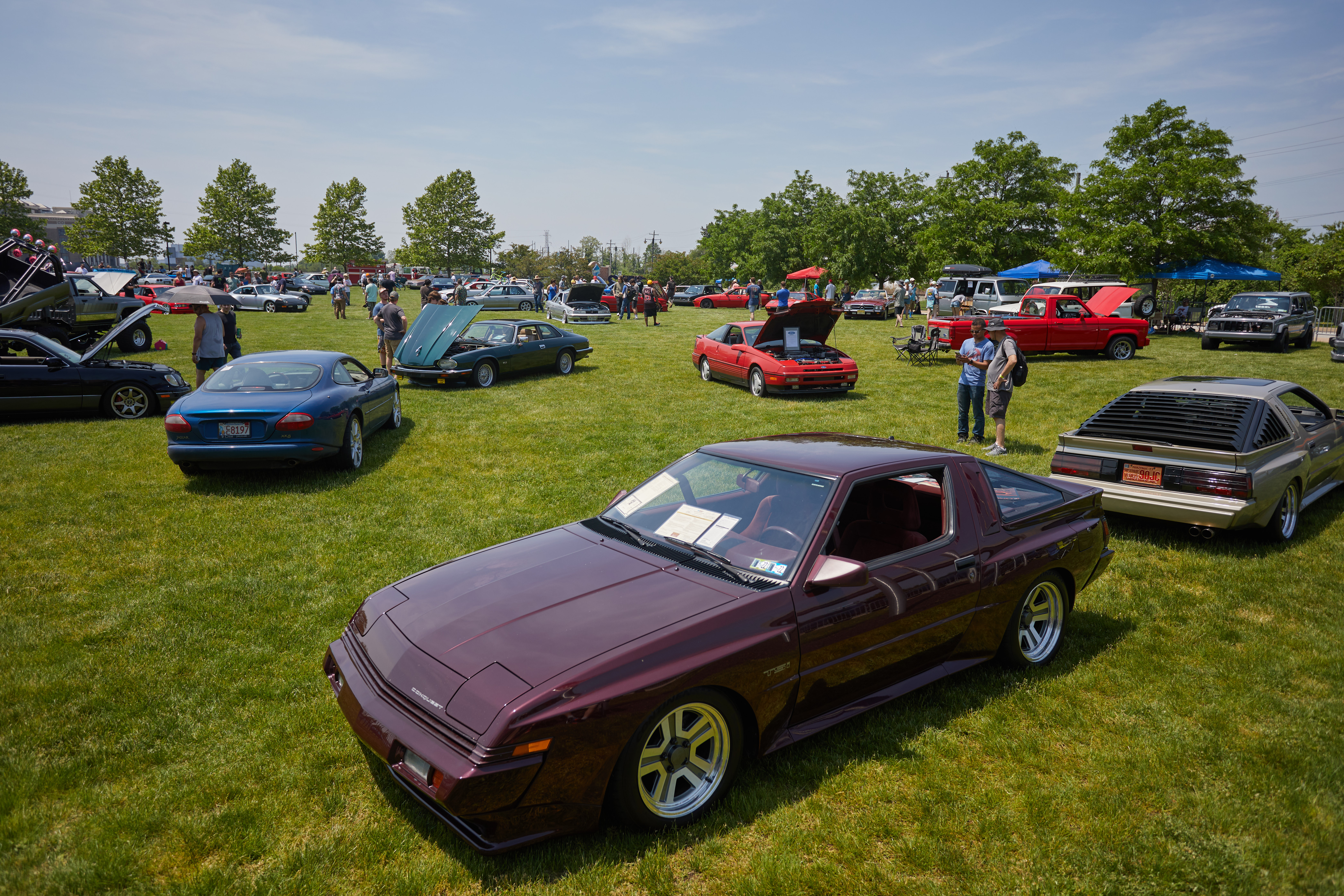Cars in grass field. A Plymouth Conquest is in the foreground.