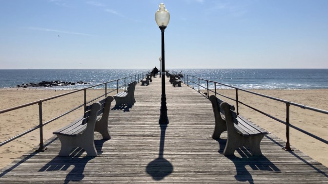 Boardwalk pier jutting into ocean in Asbury Park.