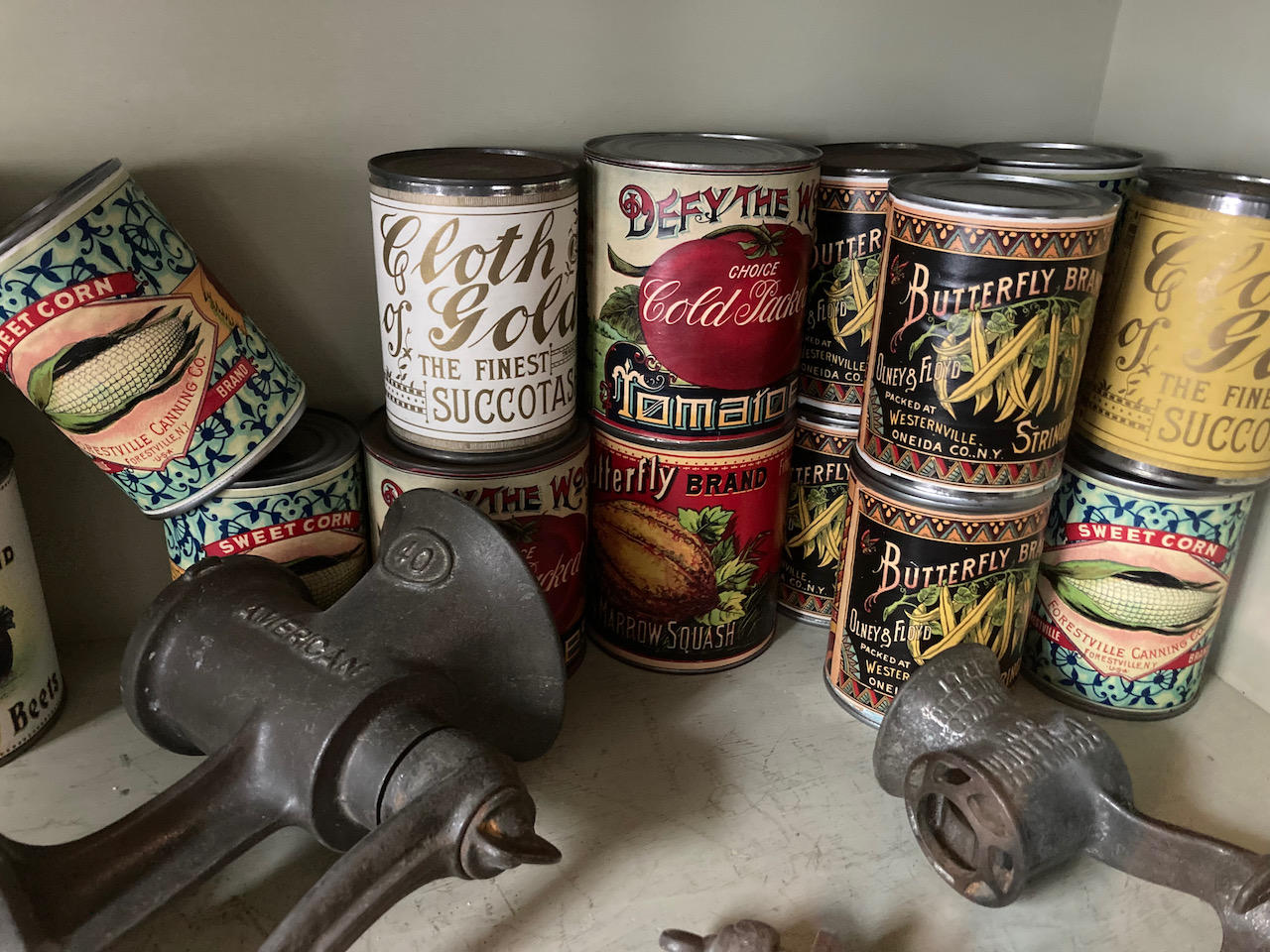 Canned goods and kitchen items in display case.