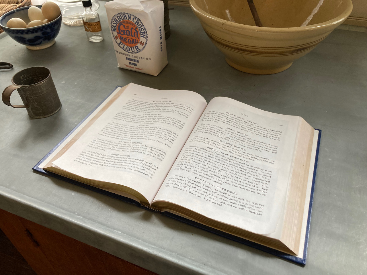 Classic cook book, open on counter in kitchen.