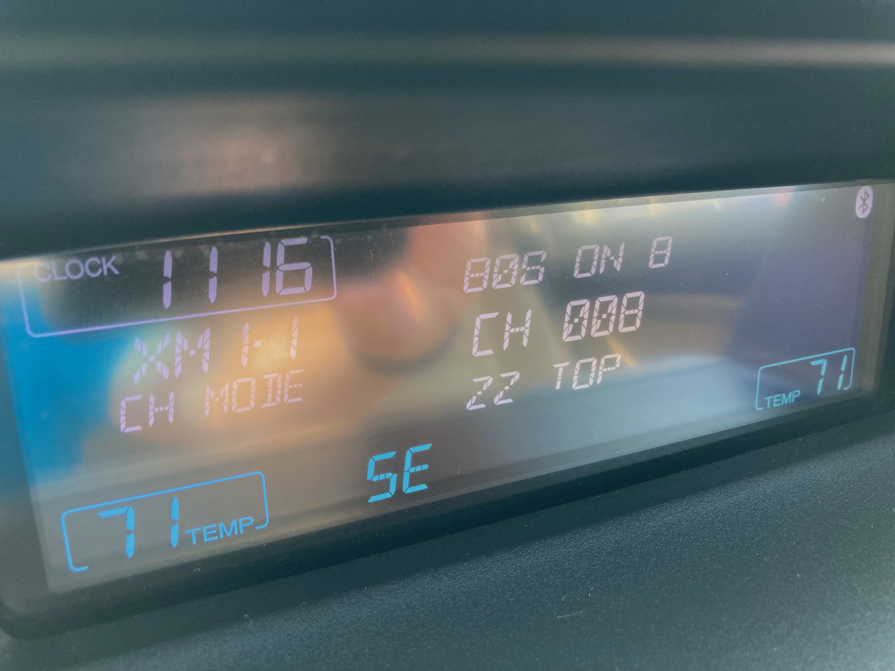 Car audio display stating 80S ON 8 CH 008 ZZ TOP