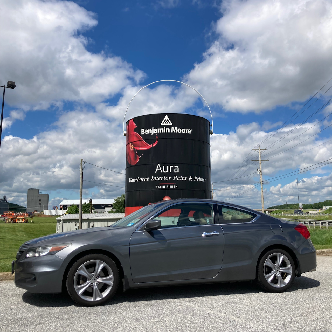 2012 Honda Accord coupe parked in front of building-sized can of paint.