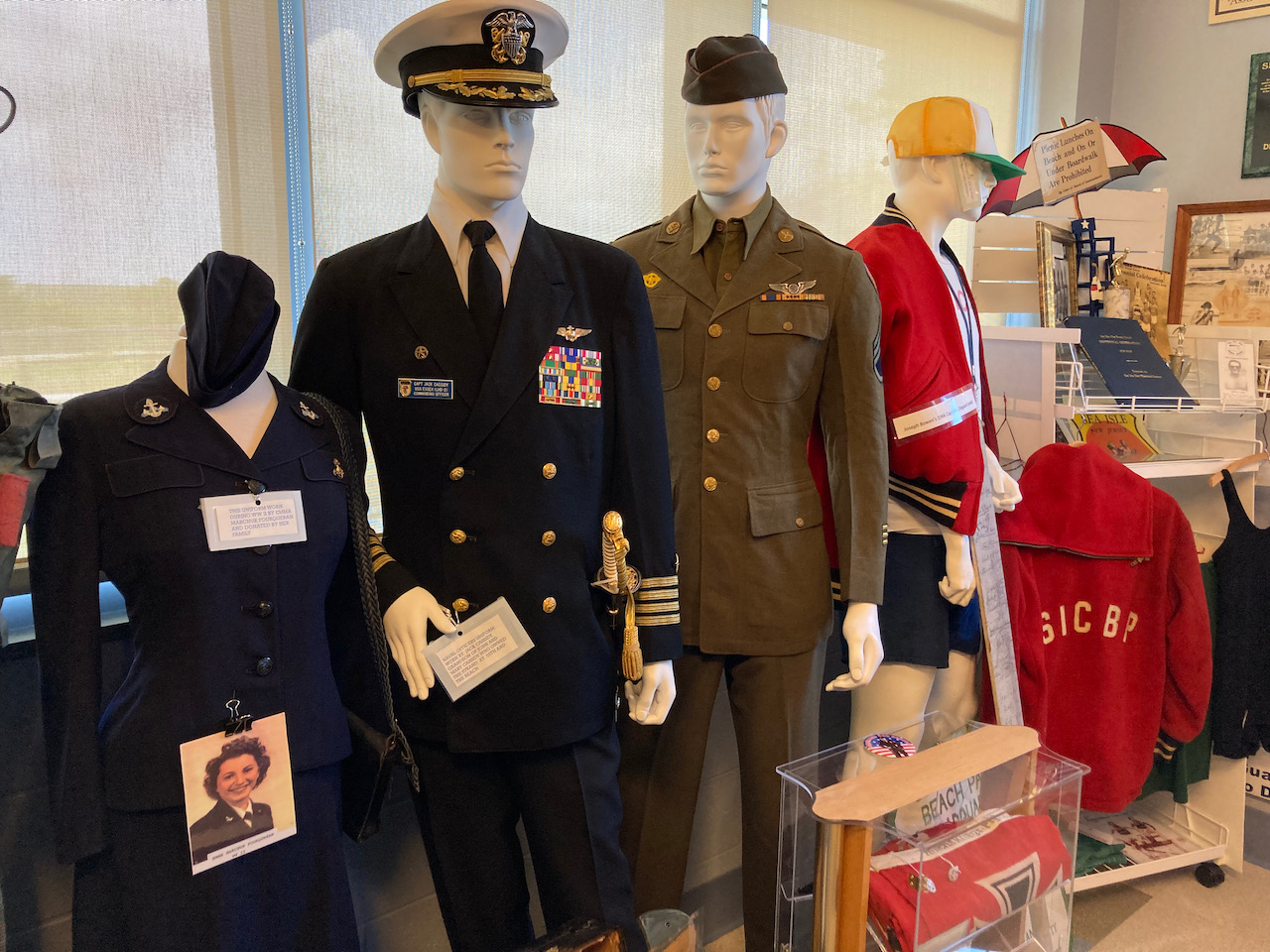 Uniforms of soldiers and life guards on mannequins.