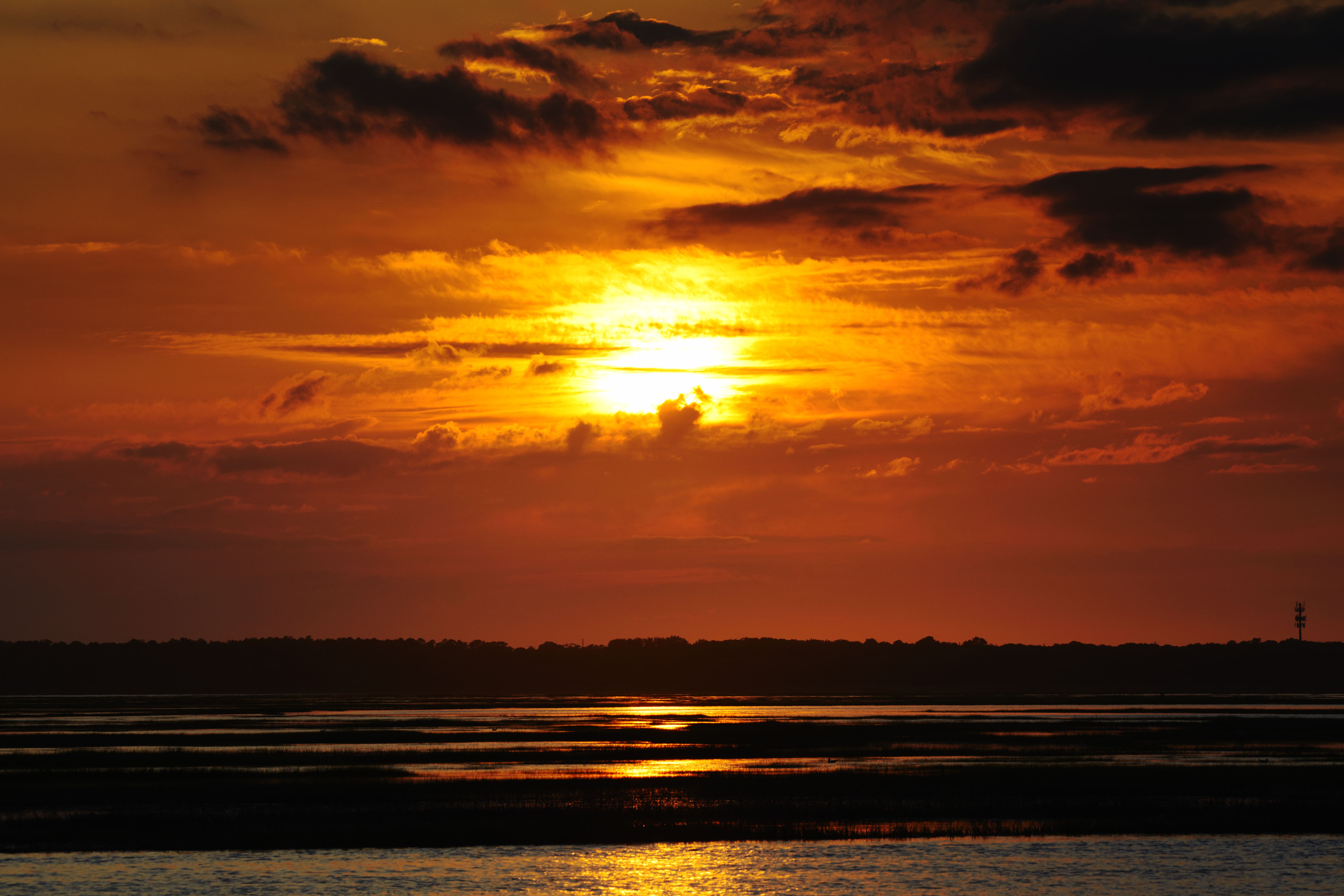 Sunset over channels and inlets on bay side of island.