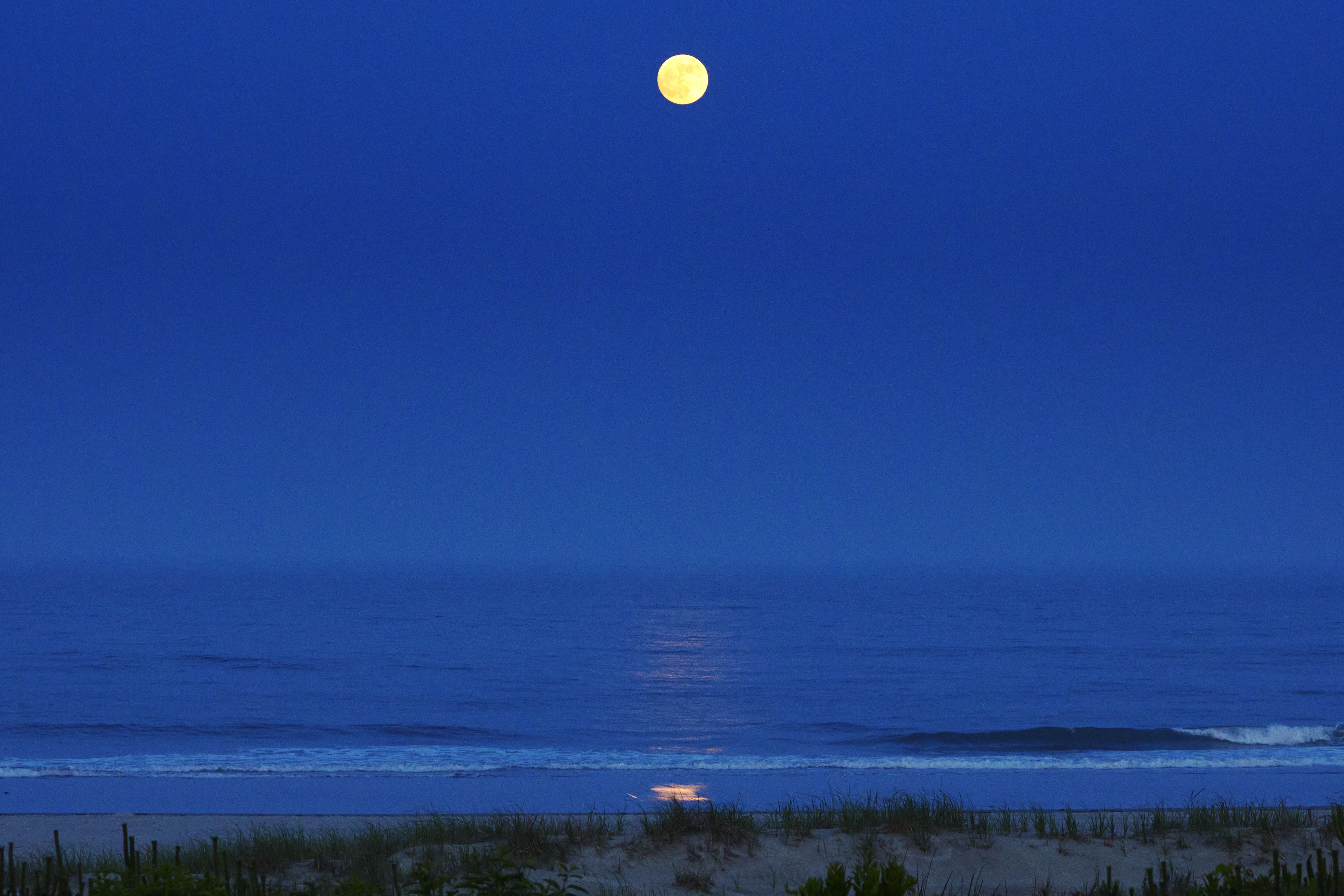 Moon over ocean and beach.