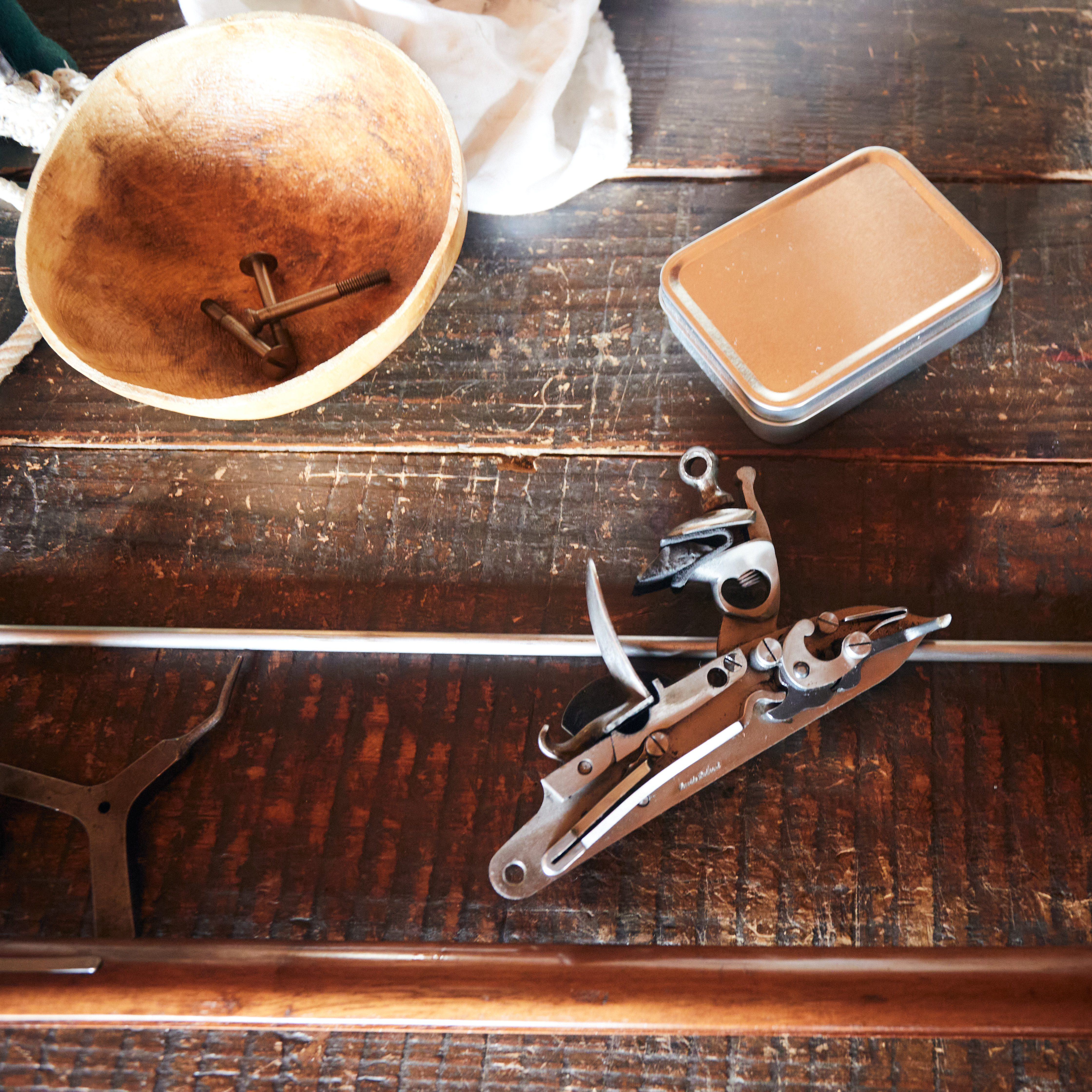 Disassembled musket on wooden table.