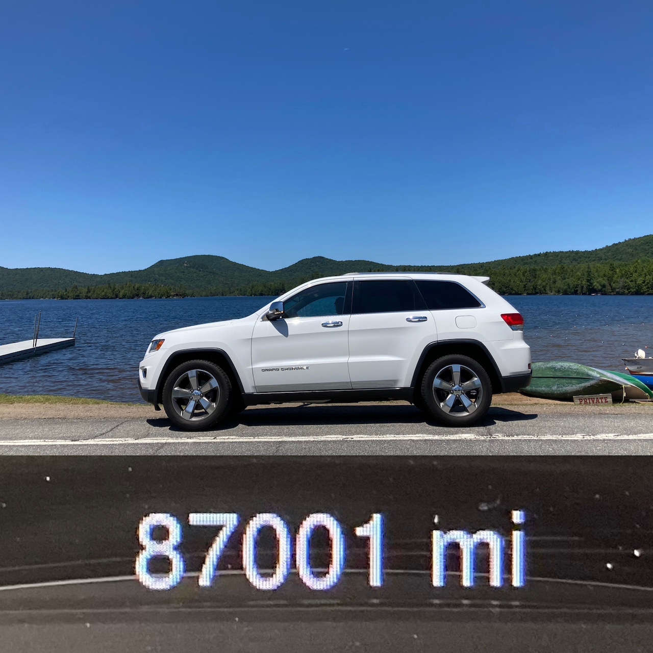 Image in two halves. Top: 2014 Jeep Grand Cherokee parked in front of Blue Mountain Lake. Bottom: car odometer reading 87001