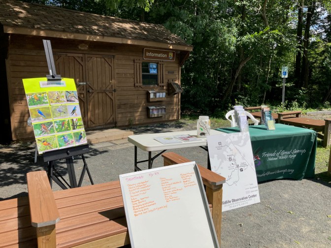 Small information cabin, with picnic tables set up for displays by Friends of Great Swamp National Wildlife Refuge.