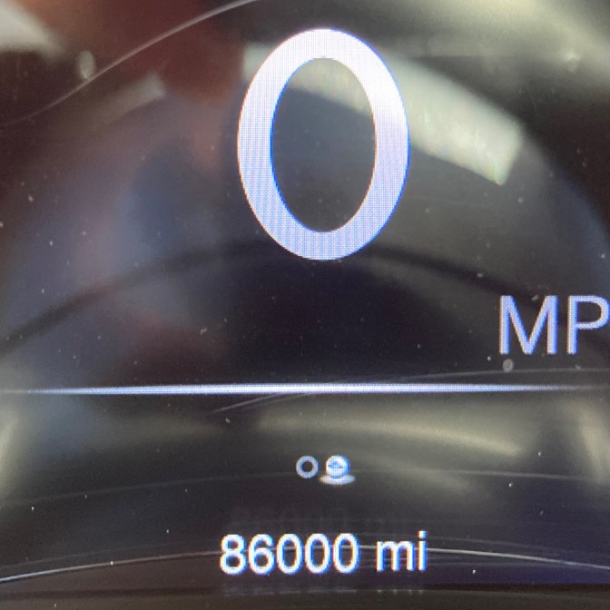 Car odometer reading 86000 miles.