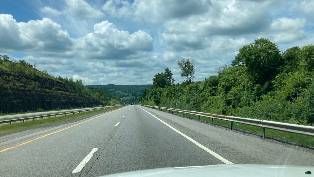 View of New York Thruway with partly cloudy skies.