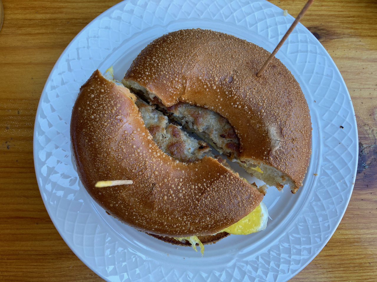 Breakfast sandwich on white plate.