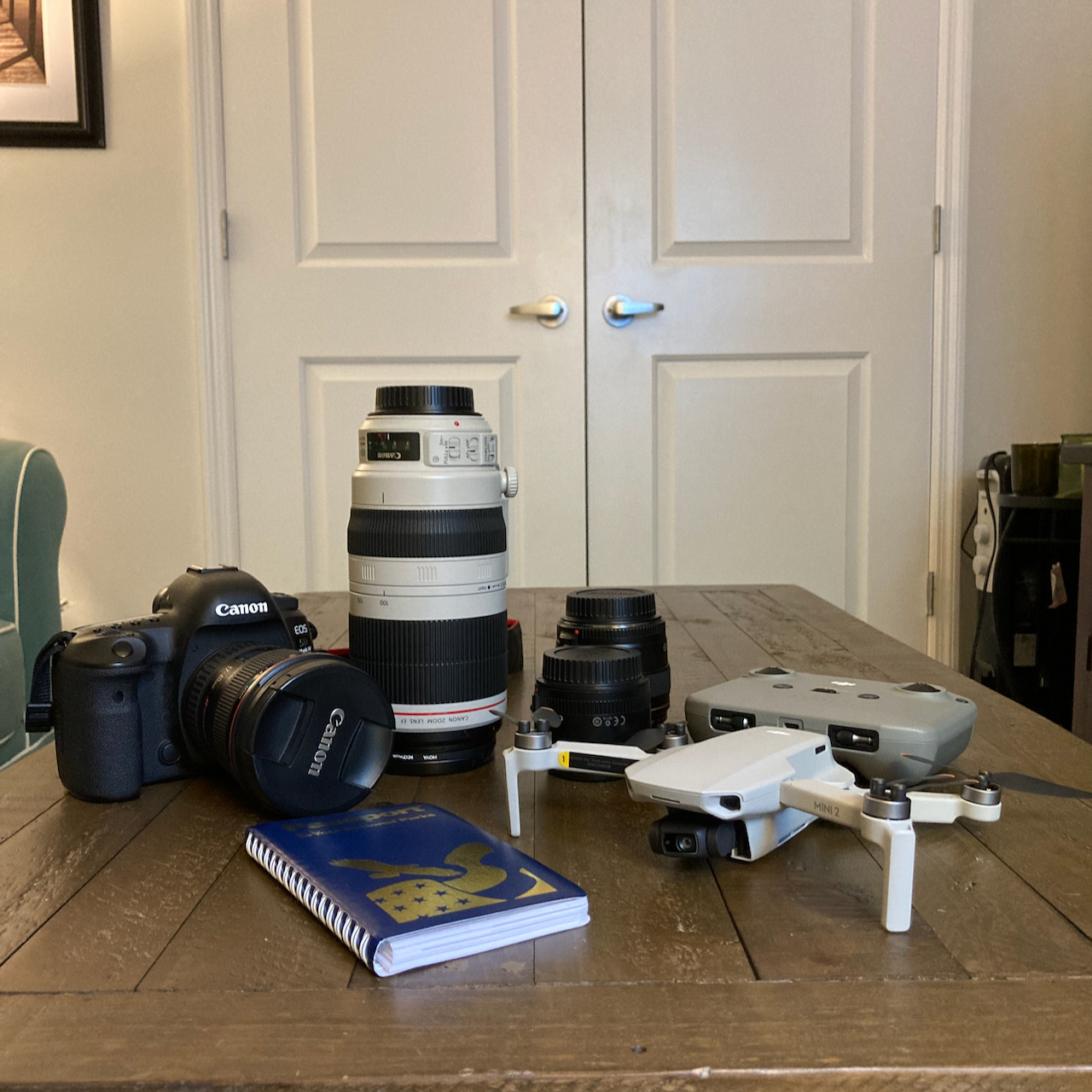 Canon camera, three lenses, DJI drone, and National Park Service passport.