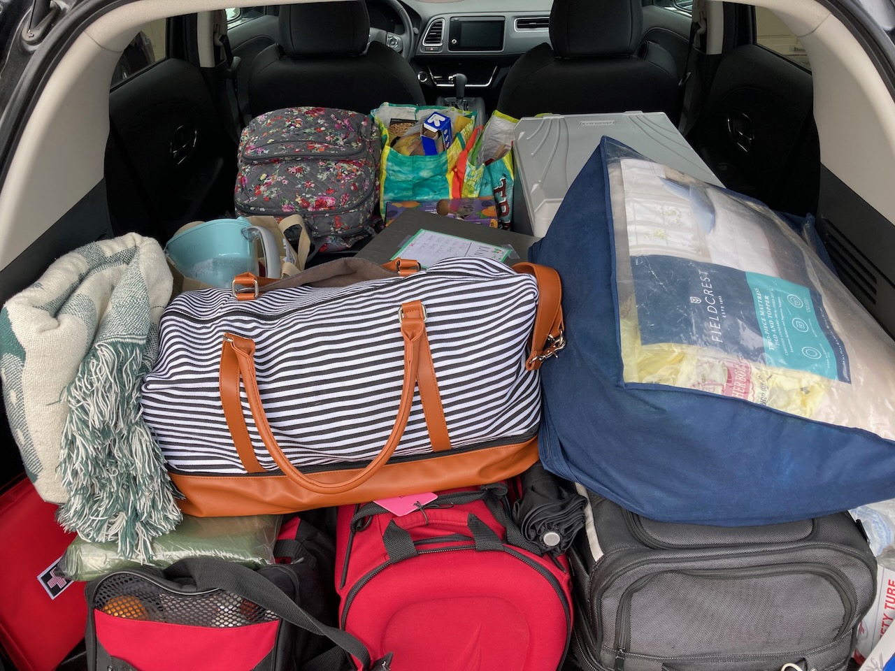 Interior of 2021 Honda HR-V filled with luggage.