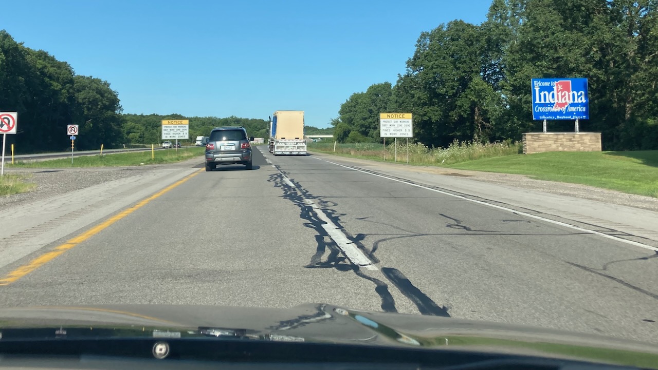 I-80 with WELCOME TO INDIANA sign on side of road.