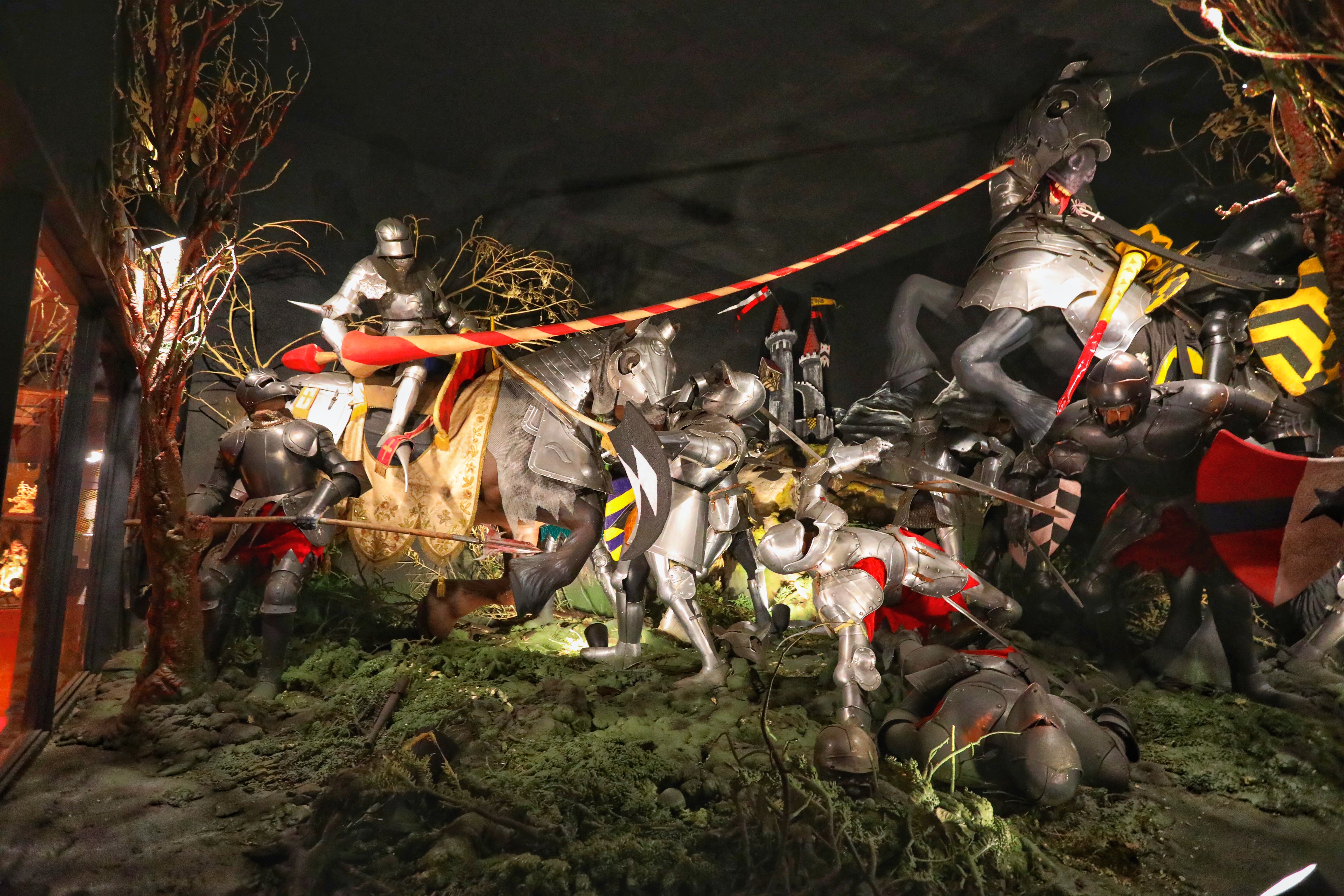 Knights in armor fighting on battlefield.