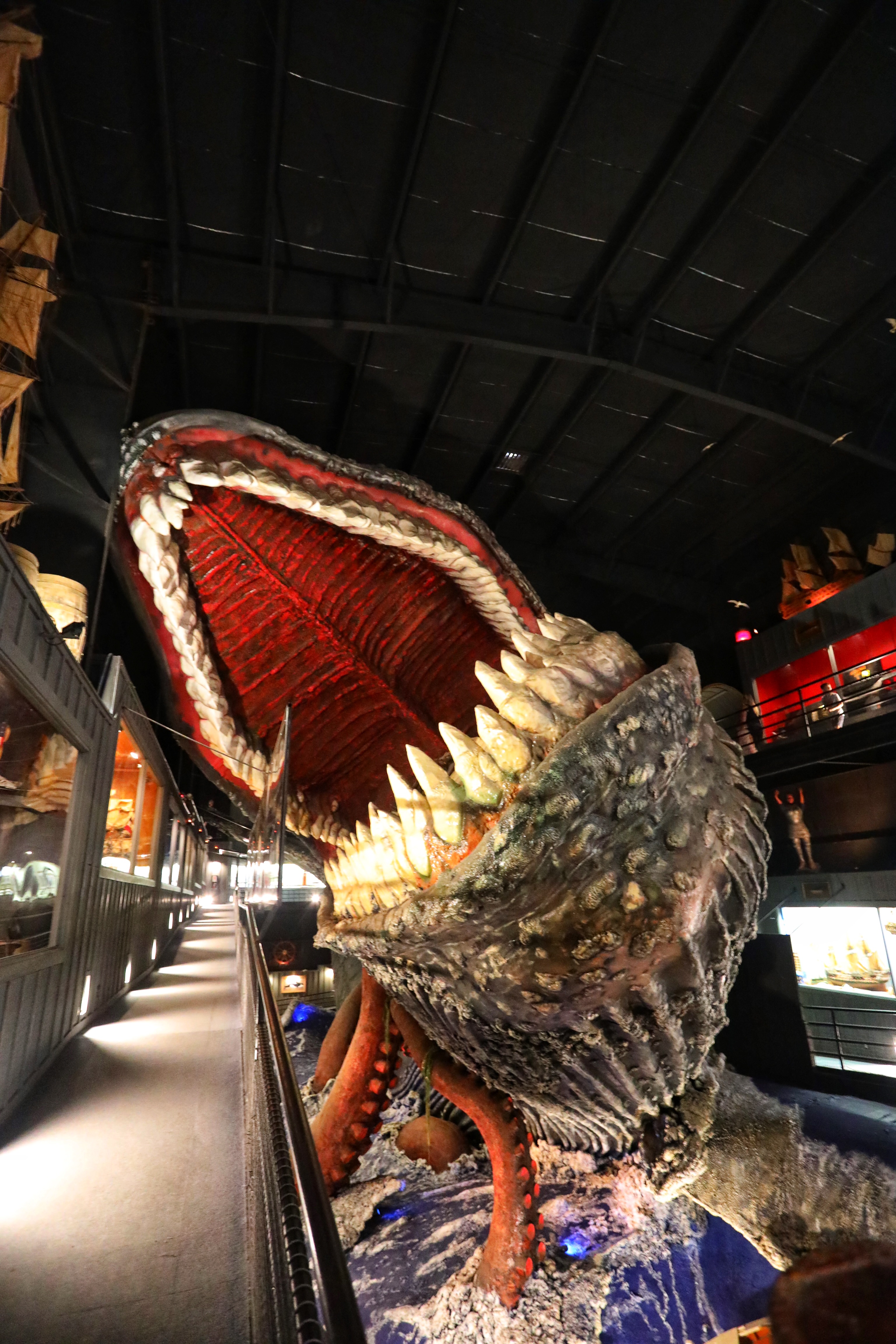 Giant whale with open mouth in middle of exhibit hall.