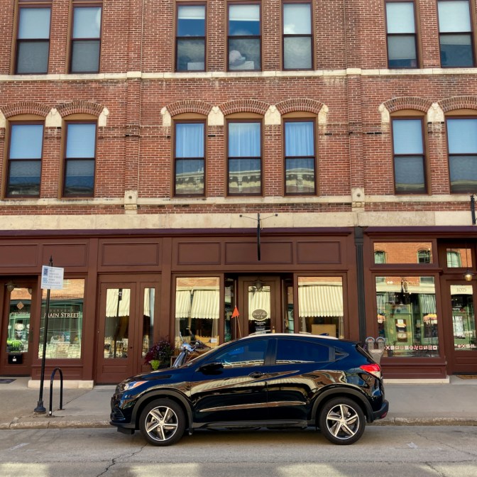 2021 Honda HR-V parked in front of brick building.