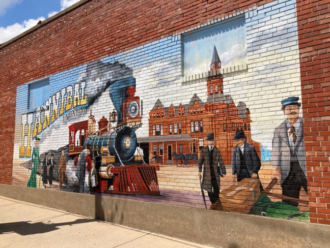 Mural of passengers boarding train, with words HANNIBAL UNION DEPOT on mural.