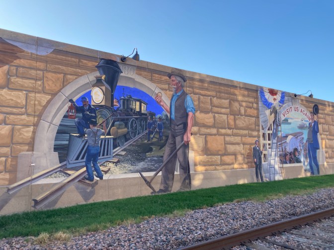 Two panels of mural - one with railroad engine on tracks, other with depicting President Taft's visit to Cape Girardeau.