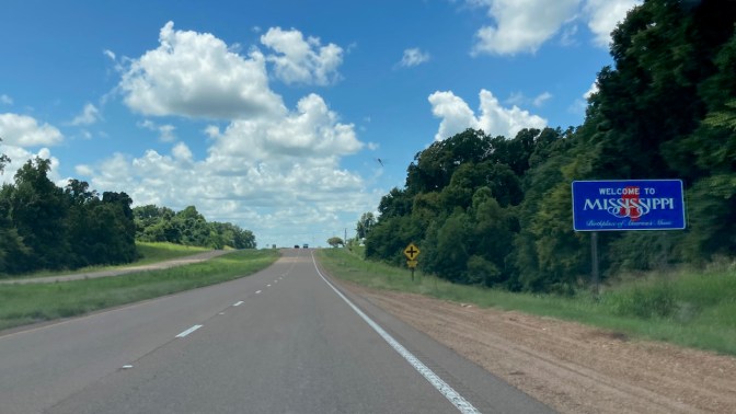 WELCOME TO MISSISSIPPI sign along highway.