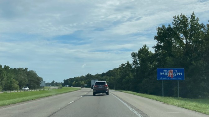 Interstate highway, with WELCOME TO MISSISSIPPI sign on side of road.