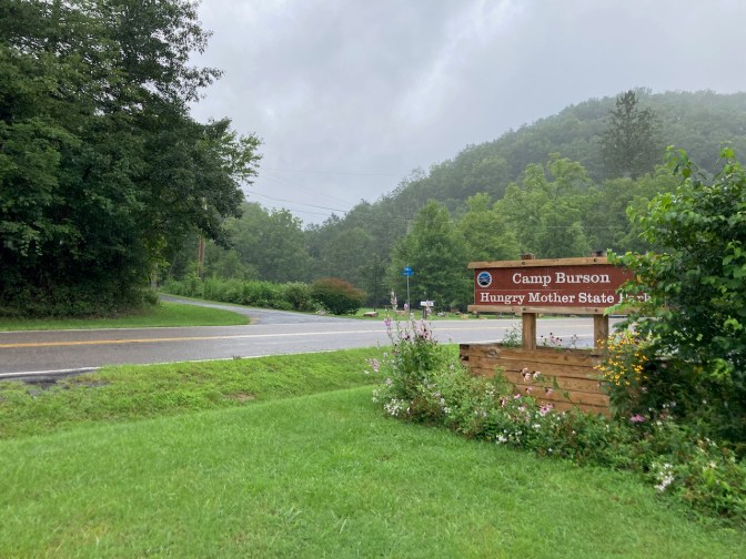 Mountains in background with sign in foreground that reads CAMP BURSON HUNGRY MOTHER STATE PARK.